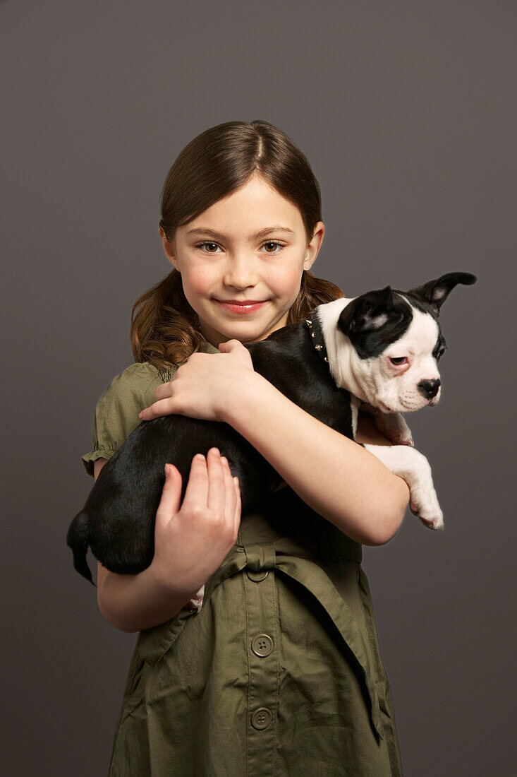 Little Girl Holding Dog