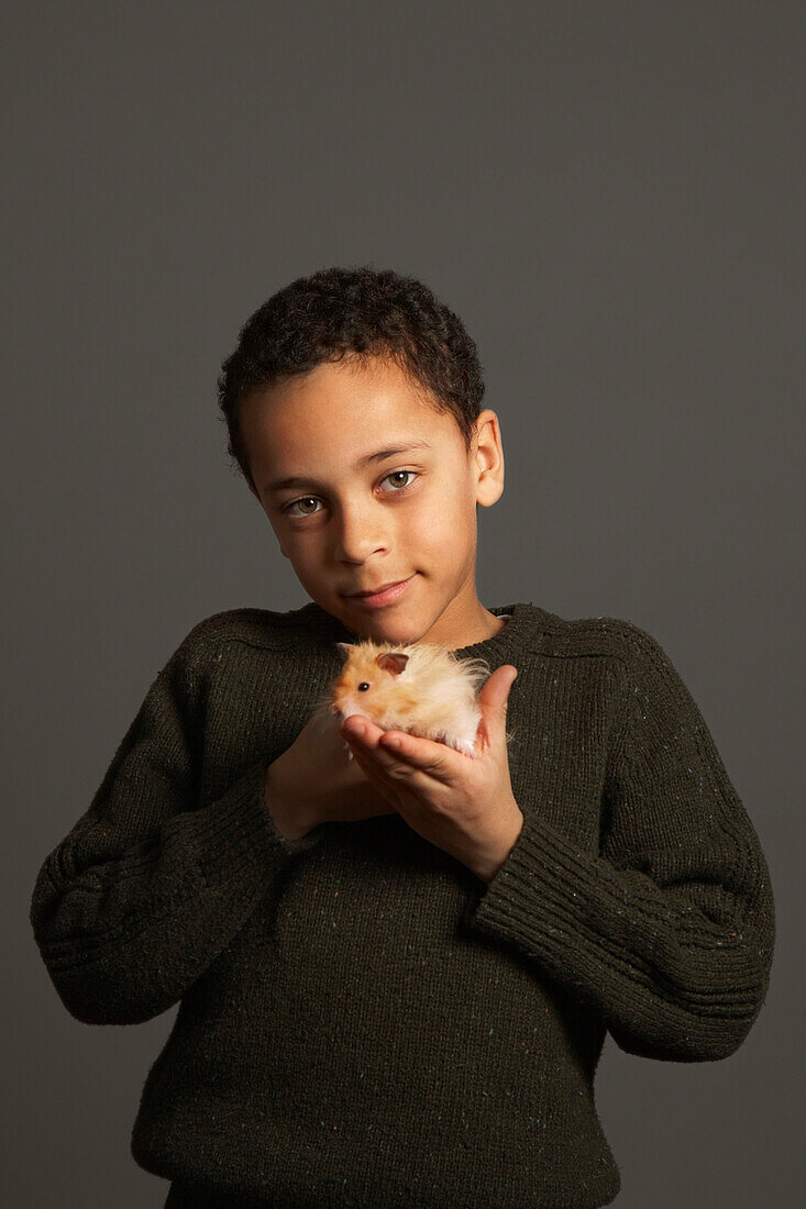 Little Boy Holding Hamster