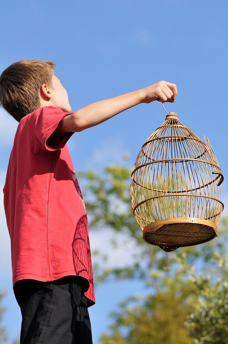 Boy Holding Empty Birdcage