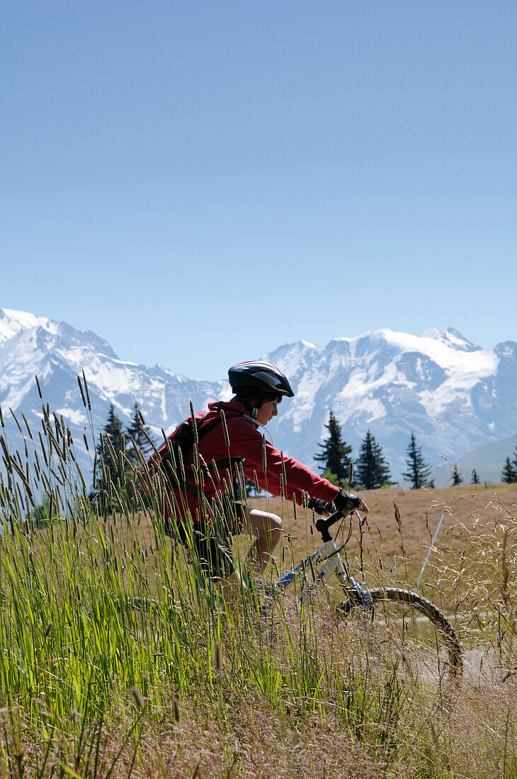 Boy Riding Bicycle in Mountains,Alps,France