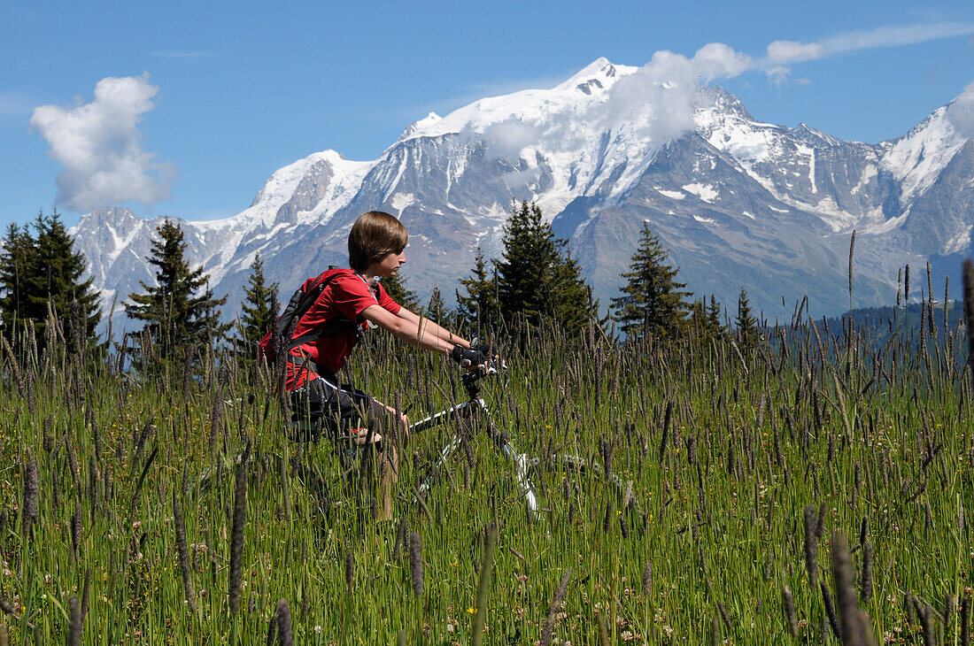 Boy Riding Bicycle in Mountains,Alps,France