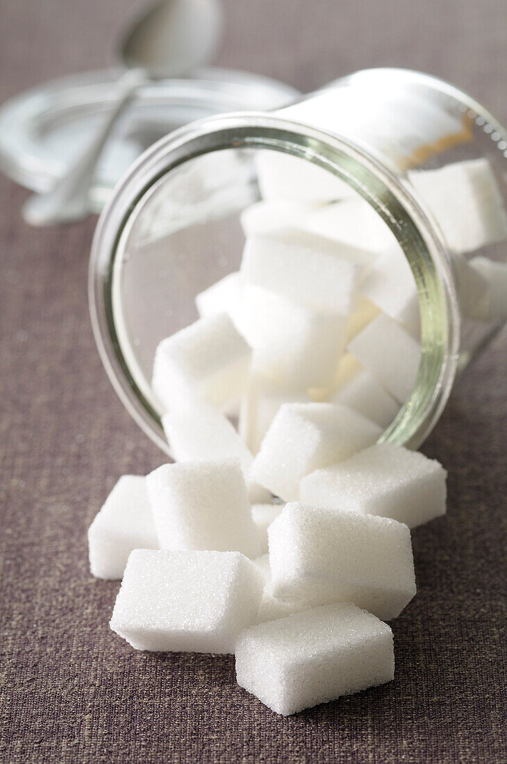Close-up of Jar of Sugar Cubes Spilling