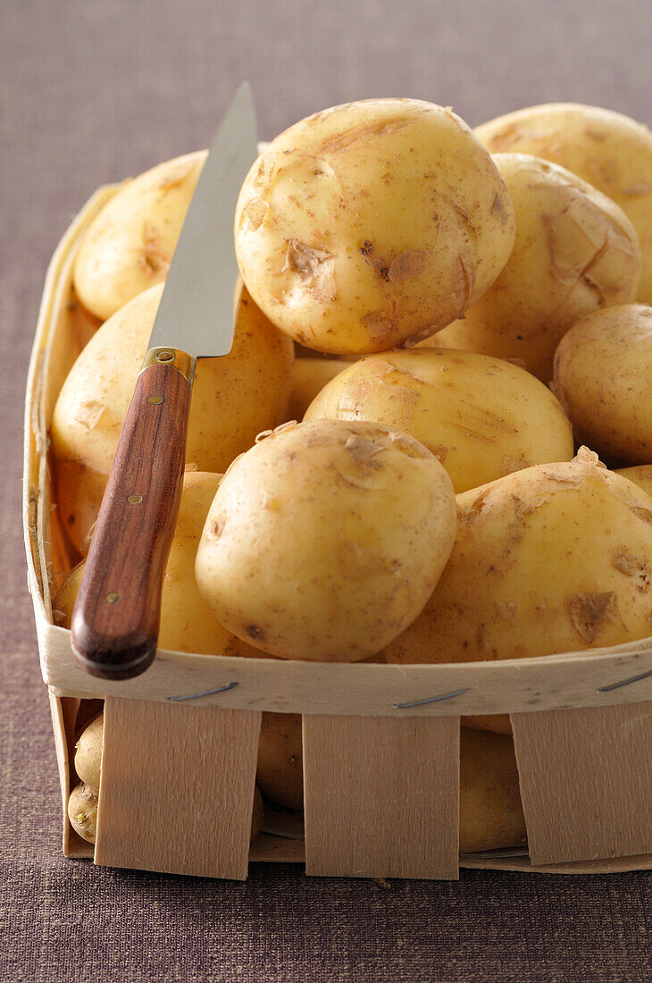 Basket of Potatoes with Knife