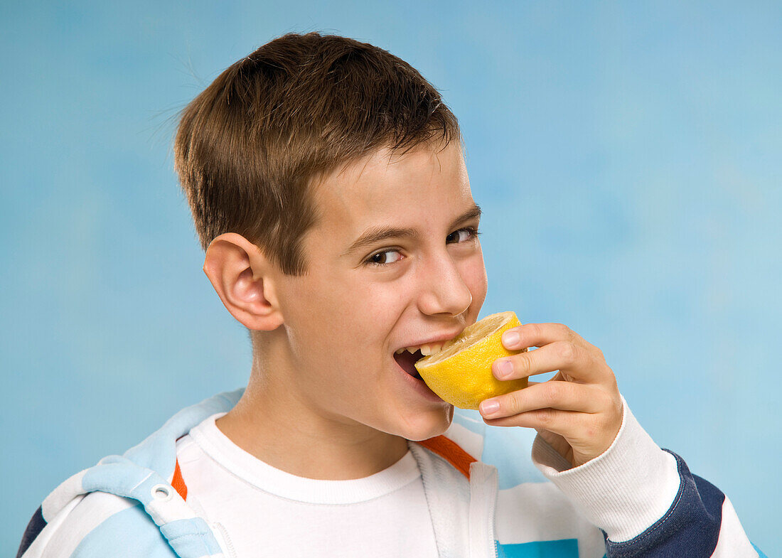 Boy Eating a Lemon