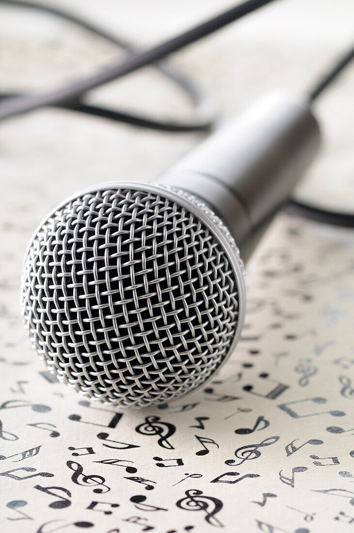 Close-up of Microphone on Music Note Background