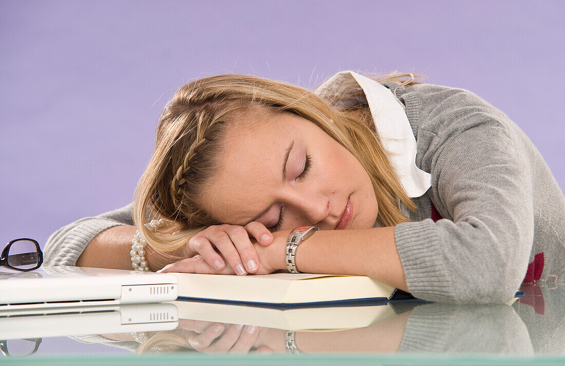 Young Woman Falling Asleep at Desk
