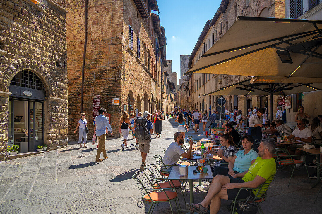 View of cafe and bar in narrow street in San Gimignano,San Gimignano,Province of Siena,Tuscany,Italy,Europe
