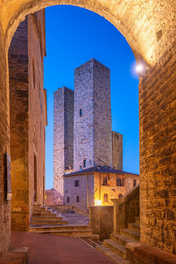 View of towers in Piazza del Duomo at dusk,San Gimignano,UNESCO World Heritage Site,Province of Siena,Tuscany,Italy,Europe