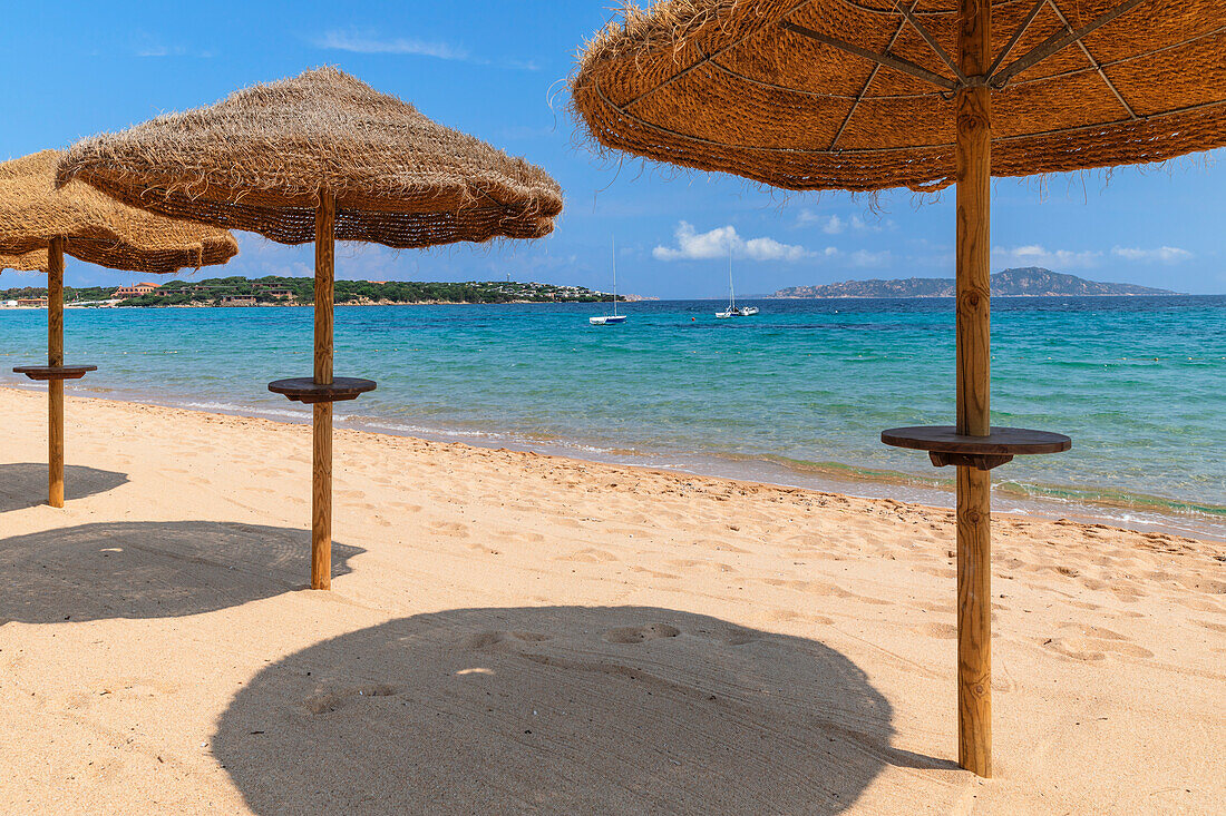 Straw parasols,Porto Pollo Beach,Porto Puddu,Gallura,Sardinia,Italy,Mediterranean,Europe