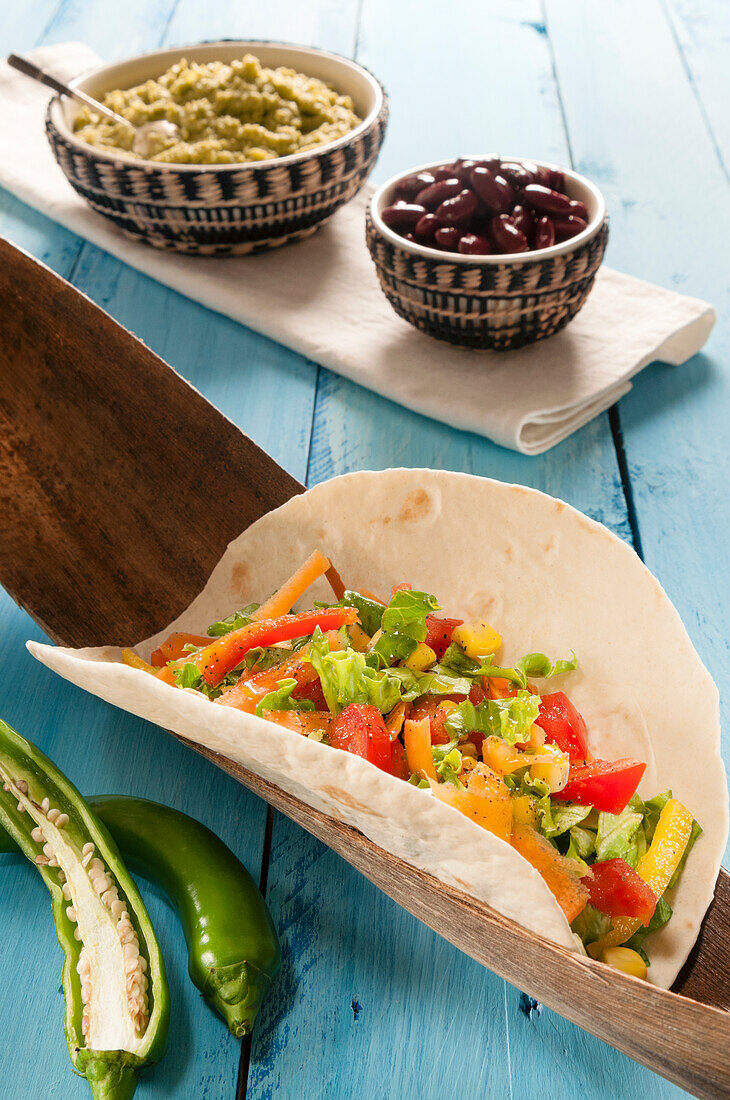 Vegetarian Taco in flour Tortilla with guacamole,hot green peppers and beans,Mexico,North America