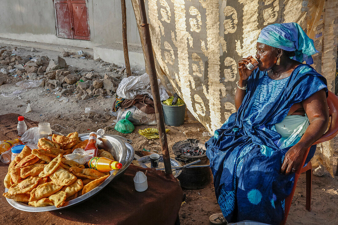 Snack vendor drinking coffee in Niakhar,Senegal,West Africa,Africa