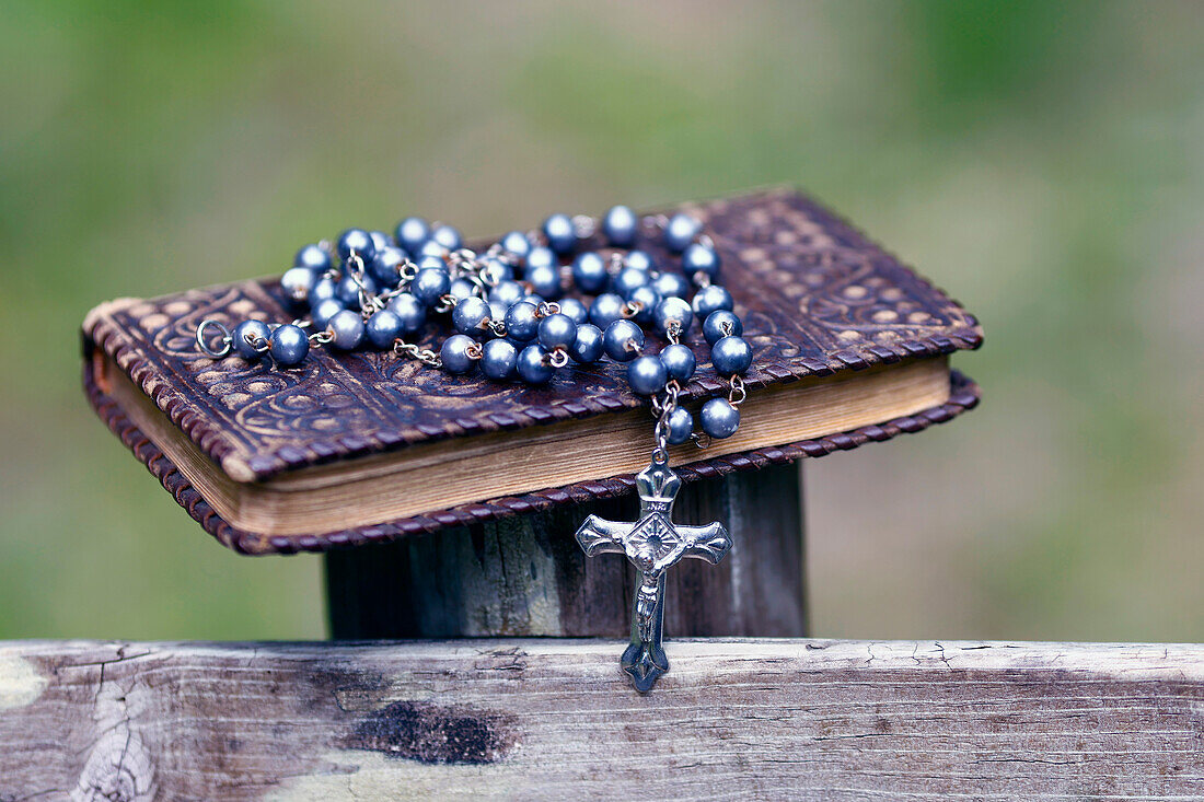 Bible and Catholic rosary beads on wood,Les Contamines,Haute-Savoie,France,Europe