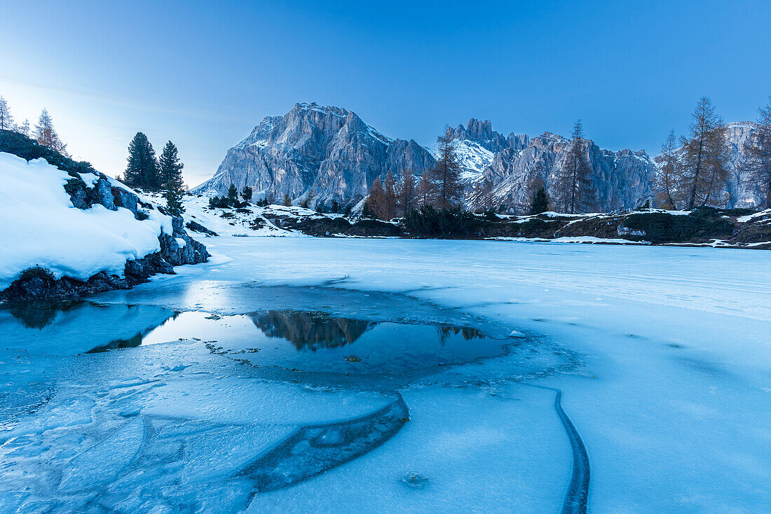 Dusk on the frozen lake of Limides,Falzarego mountain pass,Dolomites,South Tyrol,Italy,Europe