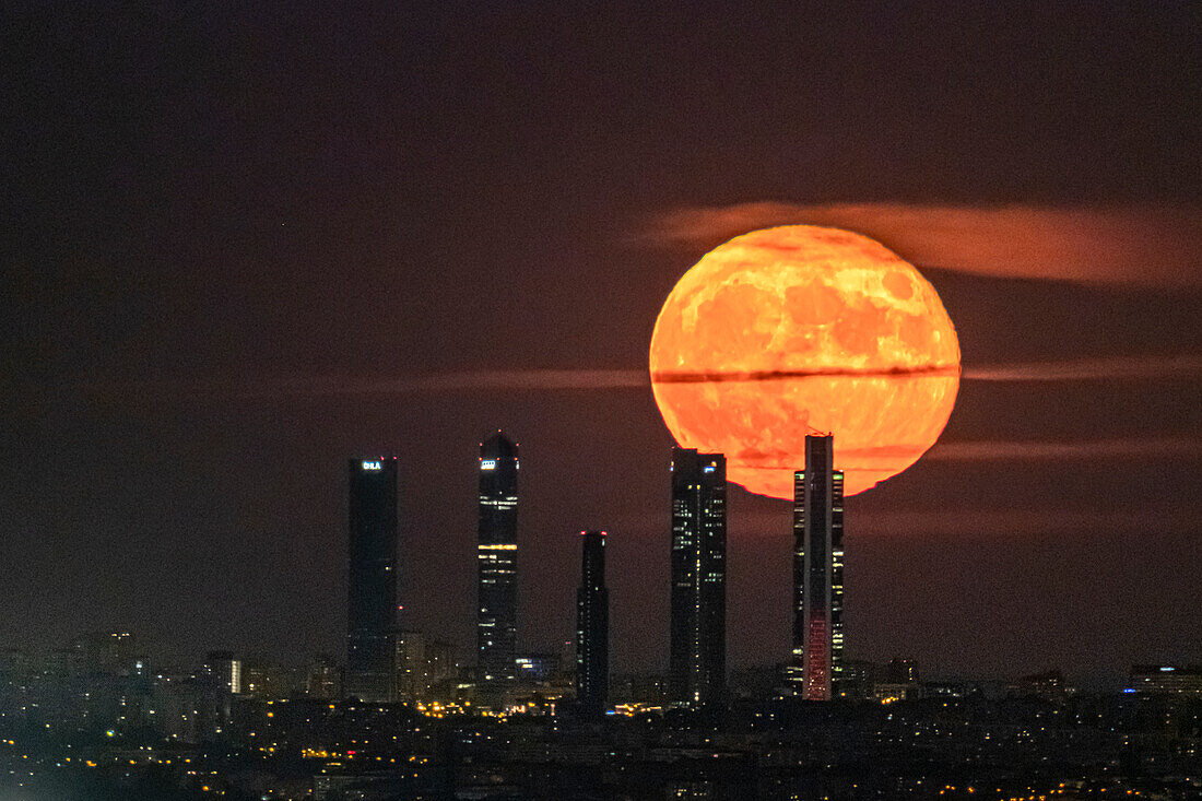 The Blue Moon,full moon at perigee,behind the Cuatro Torres skyscrapers in Madrid,Spain,Europe