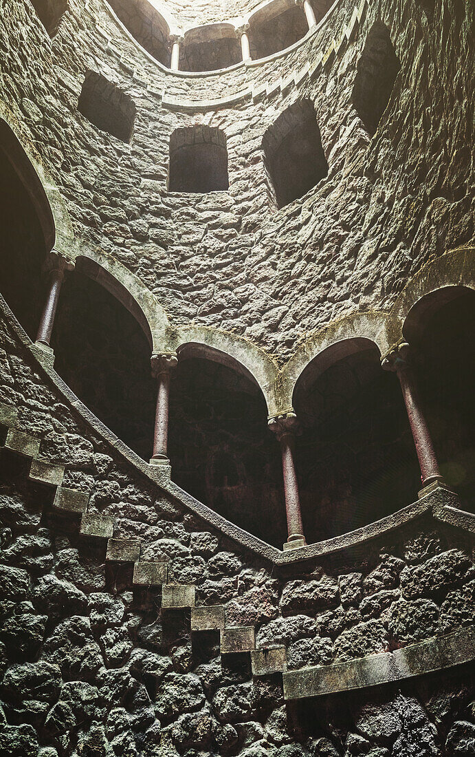 Blick auf Wendeltreppen am Initiationsbrunnen, der angeblich im 19. Jahrhundert von Freimaurern für zeremonielle Zwecke genutzt wurde, in Quinta da Regaleira, Sintra, Portugal, Europa