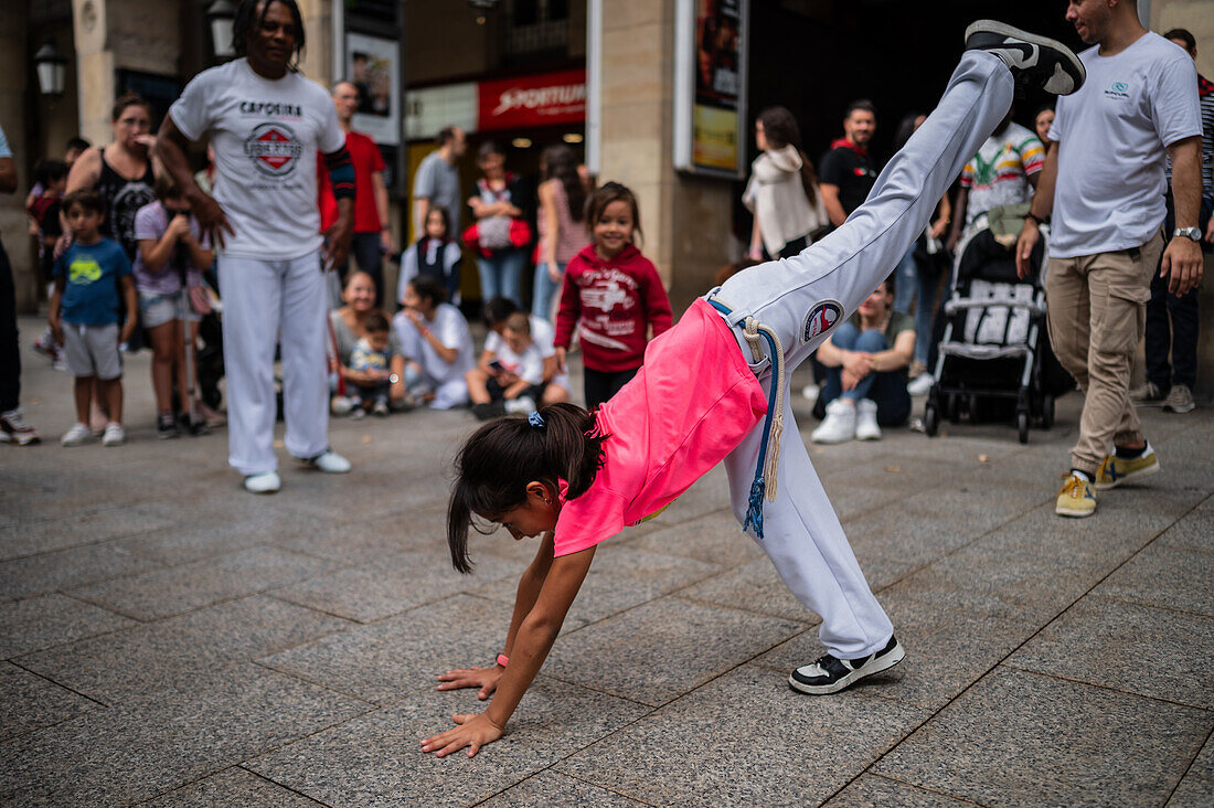 Members of Mestre Branco Capoeira Escola demonstrate in the street during the Fiestas of El Pilar in Zaragoza,Aragon,Spain