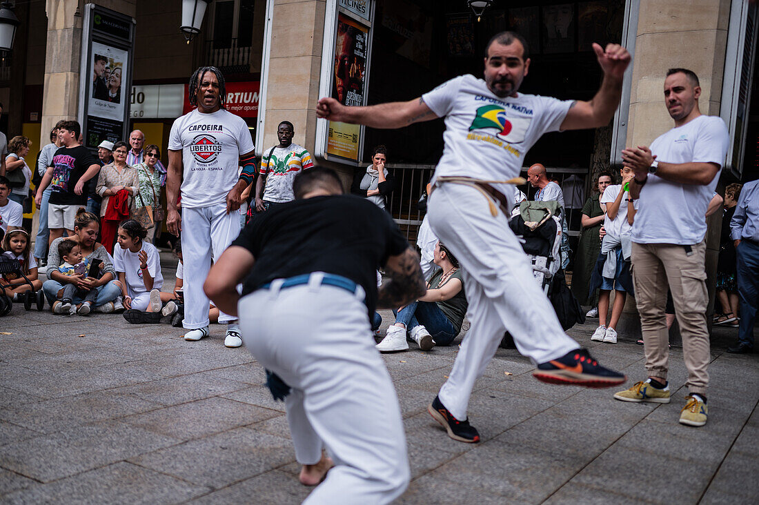 Members of Mestre Branco Capoeira Escola demonstrate in the street during the Fiestas of El Pilar in Zaragoza,Aragon,Spain