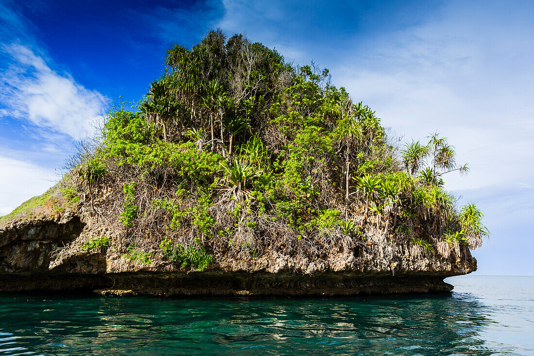 A view of islets covered in vegetation from inside the natural protected harbor in Wayag Bay,Raja Ampat,Indonesia,Southeast Asia,Asia