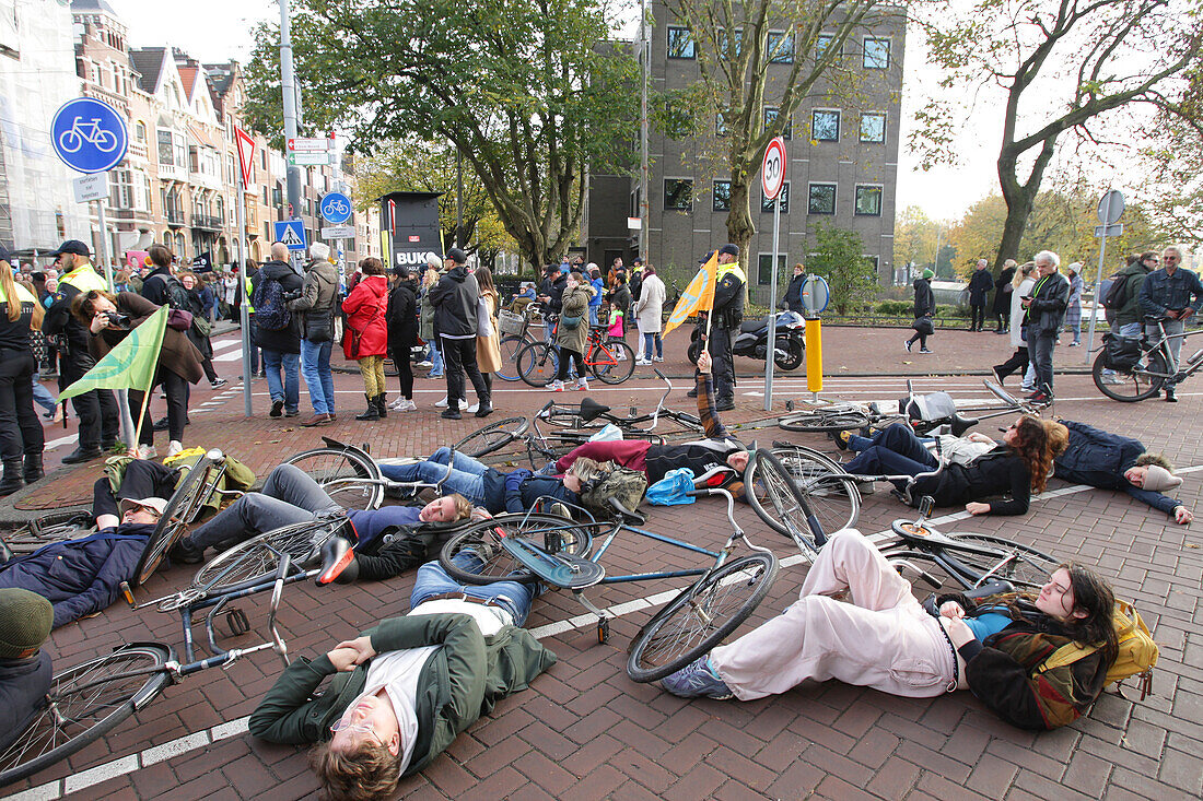 Environmental activists from Extinction Rebellion block the street attend the March For Climate And Justice on November 12,2023 in Amsterdam,Netherlands. Protestors demand action from the Dutch government and world leaders to combat the climate change crisis,heat records are being broken again and again,resulting in profound changes for all life on Earth. An estimated 70,000 people have walked on Sunday with the climate march in Amsterdam,according to the Amsterdam municipality.