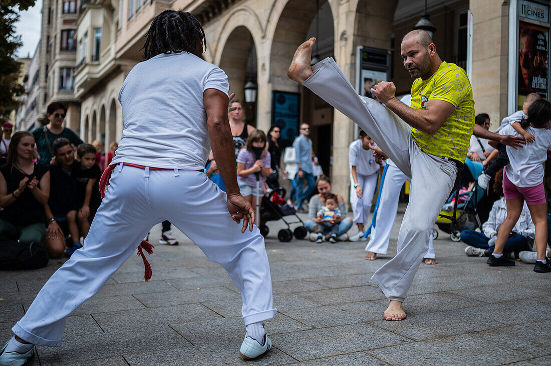 Members of Mestre Branco Capoeira Escola demonstrate in the street during the Fiestas of El Pilar in Zaragoza,Aragon,Spain