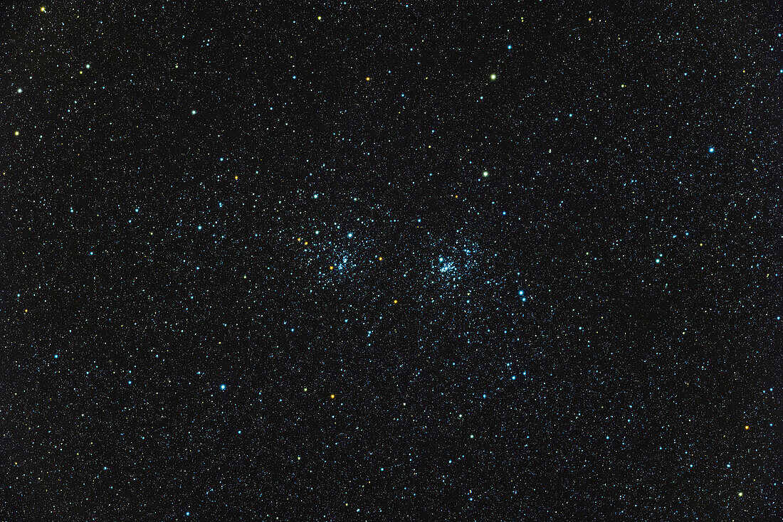 This is the famous Double Cluster,a pair of open star clusters,in Perseus. On the left is NGC 884; on the right is NGC 869. The clusters are notable for the array of yellow supergiant stars amid the hot blue stars. The clusters are thougbt to be quite young,at 3.2 millon and 5.6 million years old,respectively.