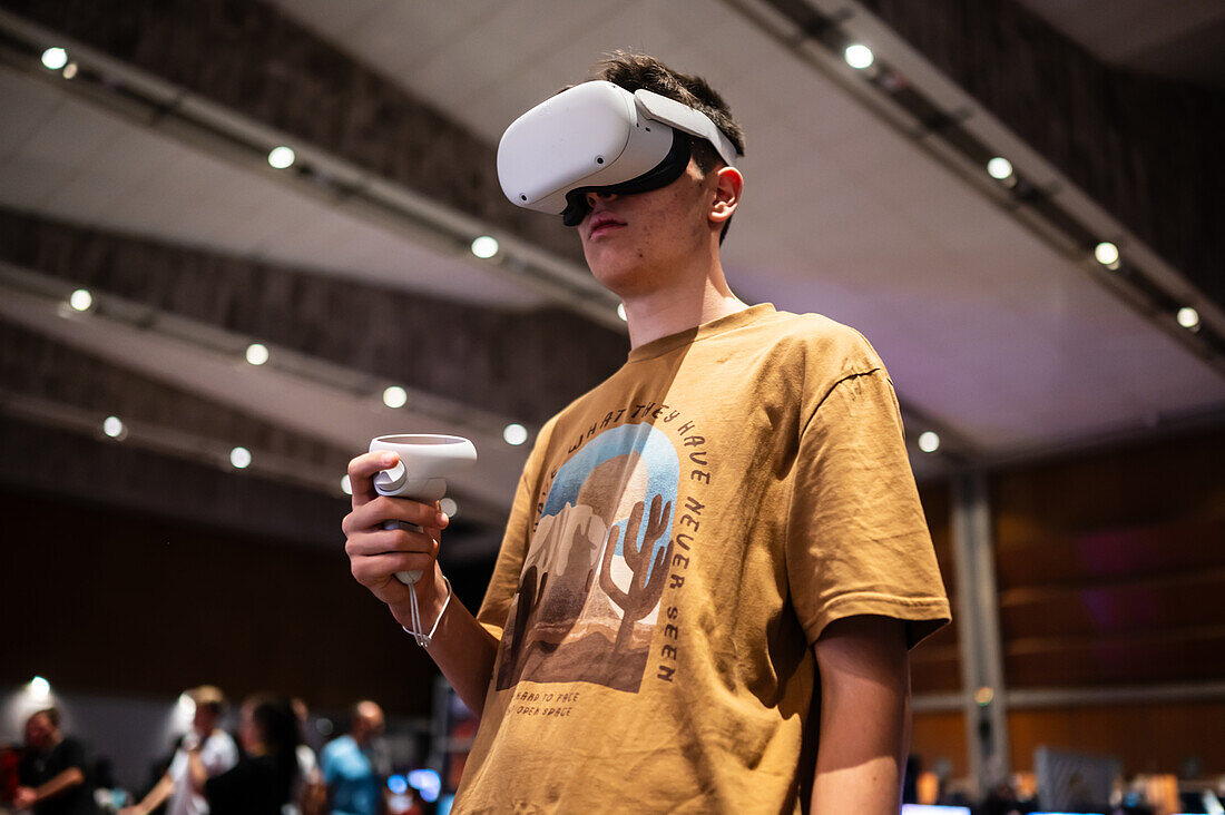 Teenager playing with Meta Quest 2 all-in-one VR headset during ZGamer,a festival of video games,digital entertainment,board games and YouTubers during El Pilar Fiestas in Zaragoza,Aragon,Spain