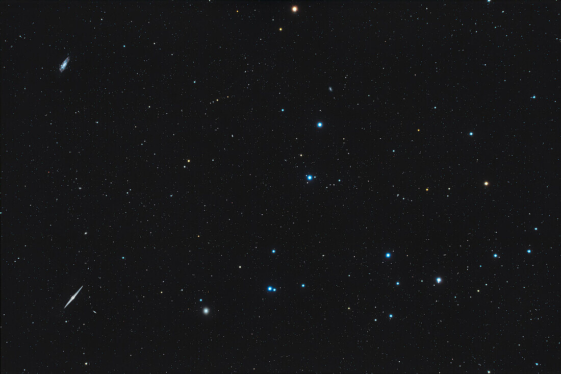 This is a framing of the large naked-eye Mel111 Coma Berenices star cluster to include some of the telescopic galaxies in the area,notably the edge-on Needle Galaxy,NGC 4565,at lower left and the spiral galaxy NGC 4559 at upper left. NGC 4494 is to the right of the Needle galaxy. Many other NGC and PGC galaxies down to 15th magnitude dot the field.