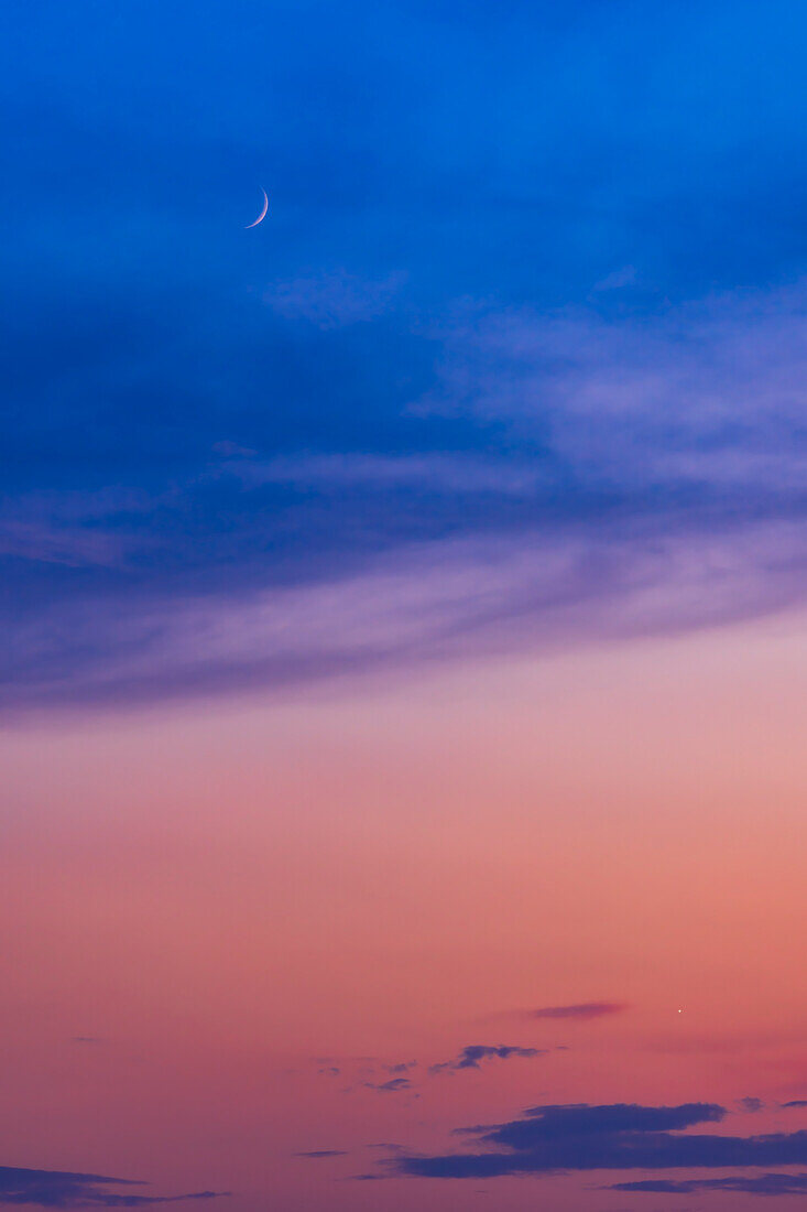 The waxing 3-day-old crescent Moon above Venus on July 20,2023 amid the colours of a late evening summer sunset. The Moon was 8° above Venus this night,so not a close conjunction. Venus is also a thin crescent but at this scale the phase of Venus is not obvious.