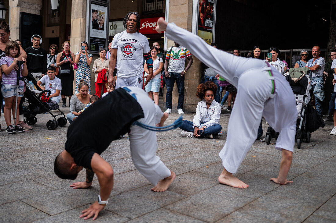 Members of Mestre Branco Capoeira Escola demonstrate in the street during the Fiestas of El Pilar in Zaragoza,Aragon,Spain