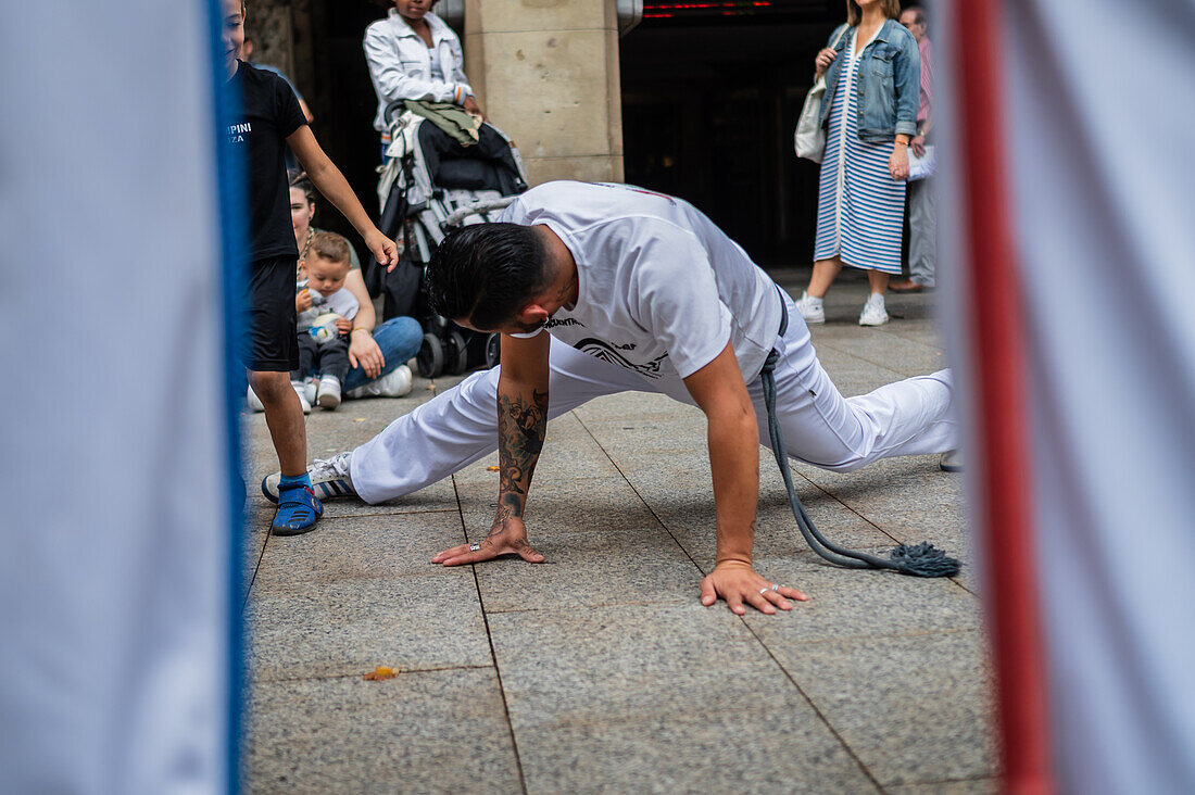 Members of Mestre Branco Capoeira Escola demonstrate in the street during the Fiestas of El Pilar in Zaragoza,Aragon,Spain