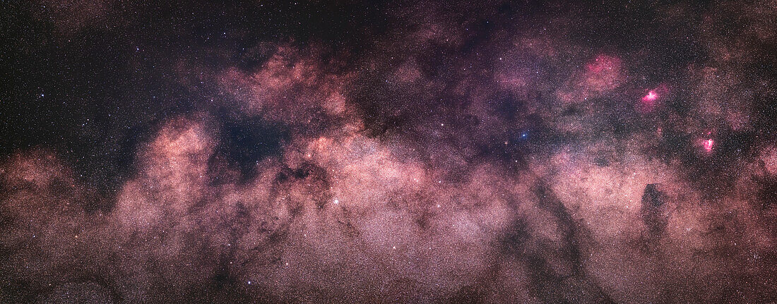 A panorama of the Milky Way from Scutum (at left) to Serpens (at right),taking in the Scutum Starcloud just left of centre and the Messier 16 and 17 nebulas (the Eagle and Swan respectively) at right. The large faint patch of red above and left of M16 is Sharpless 2-54. The star cluster M25 is at lower right. The M11 and M26 clusters are visible at centre in Scutum.