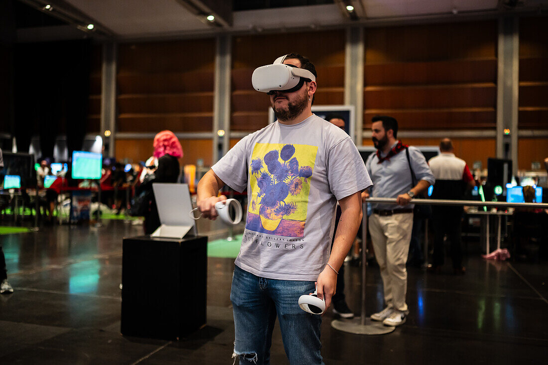 Young man playing with Meta Quest 2 all-in-one VR headset during ZGamer,a festival of video games,digital entertainment,board games and YouTubers during El Pilar Fiestas in Zaragoza,Aragon,Spain