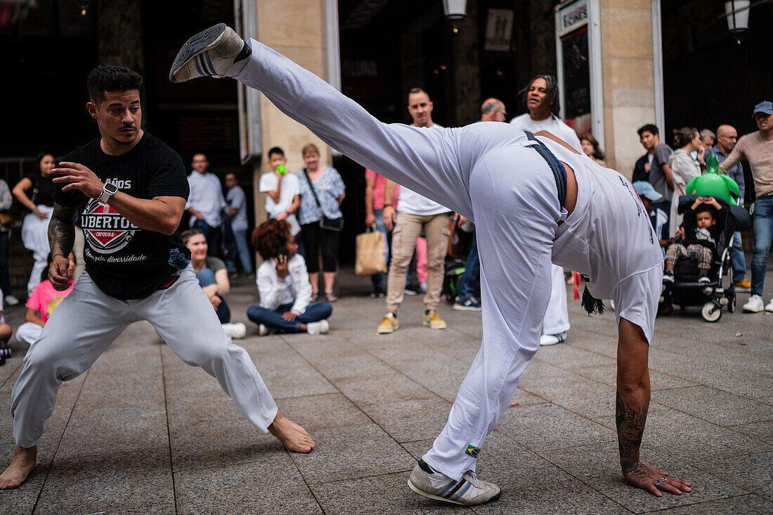 Members of Mestre Branco Capoeira Escola demonstrate in the street during the Fiestas of El Pilar in Zaragoza,Aragon,Spain