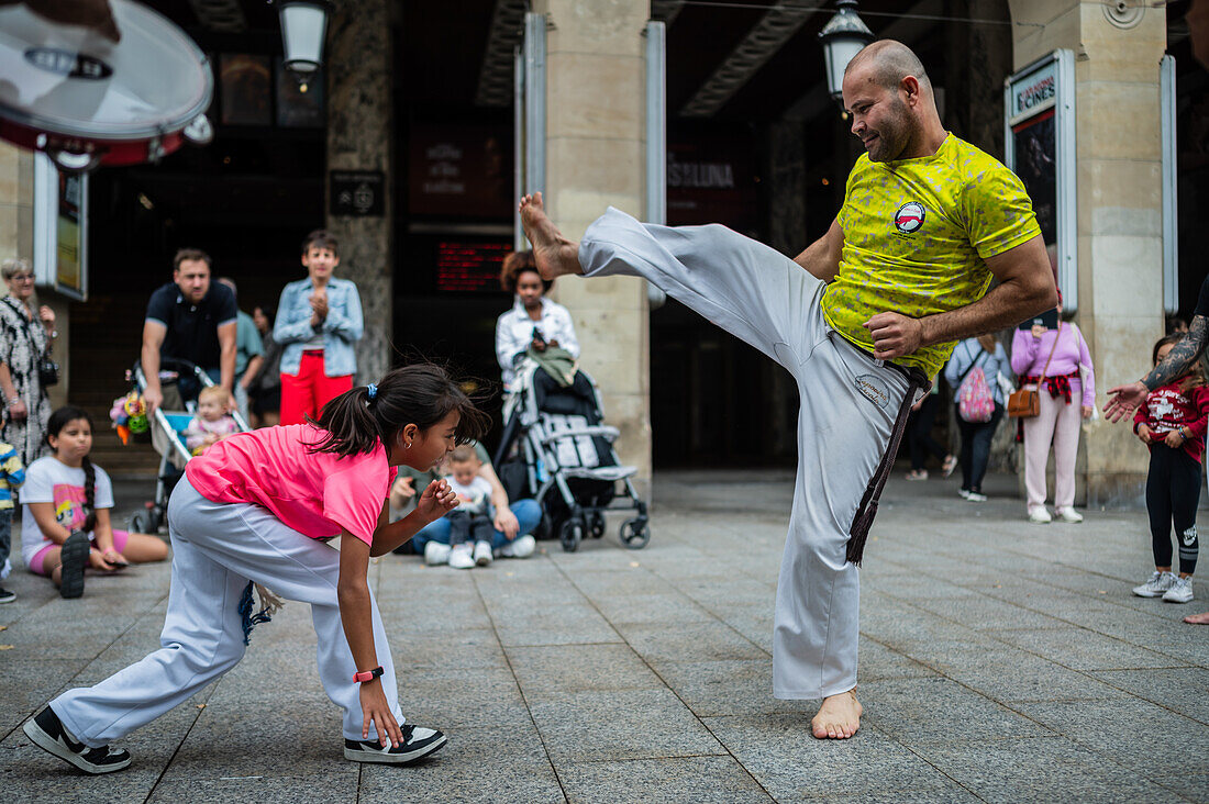 Members of Mestre Branco Capoeira Escola demonstrate in the street during the Fiestas of El Pilar in Zaragoza,Aragon,Spain