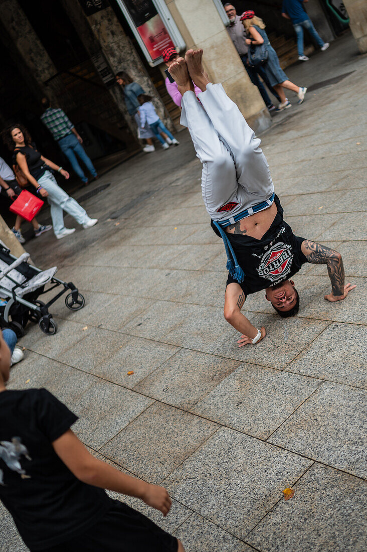 Members of Mestre Branco Capoeira Escola demonstrate in the street during the Fiestas of El Pilar in Zaragoza,Aragon,Spain