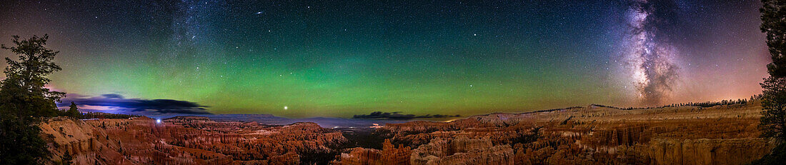 This is a 180° panorama of the night sky over the hoodoo formations of Bryce Canyon National Park,Utah,at Sunset Point. The panorama extends from the northeast (at left) where the autumn Milky Way is rising,to the southwest (at right) where the summer Milky Way and galactic core in Sagitarius are setting. This was October 11,2023. The most notable feature is the prominent arc of green airglow bands across the eastern sky,a natural sky phenemenon. Perseus is at left in the Milky Way. At top at left is the Andromeda Galaxy,M31. Below it is the blue Triangulum Galaxy,M33. Jupiter is the bright ob