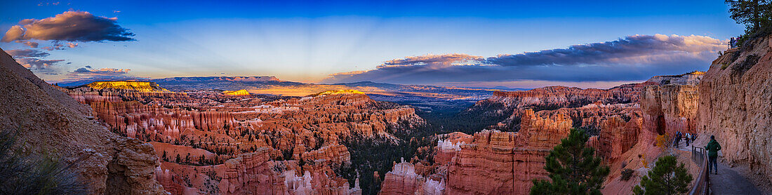 This is a roughly 150° panorama of the sunset sky at Sunset Point,Bryce Canyon,Utah,taken as the last light of the Sun was illuminating the distant buttes. The sky has subtle dark rays converging to the anti-solar point,the point opposite the Sun. These are anti-crepuscular rays – shadows cast by clouds in this case,such as the one at left.