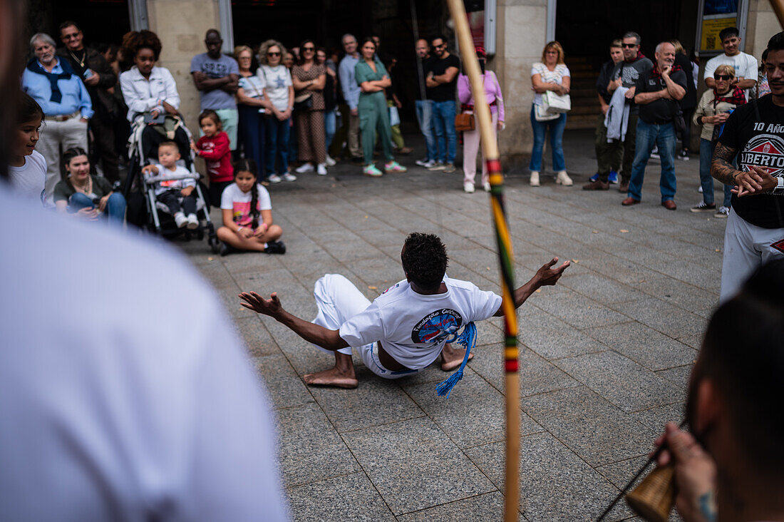 Members of Mestre Branco Capoeira Escola demonstrate in the street during the Fiestas of El Pilar in Zaragoza,Aragon,Spain