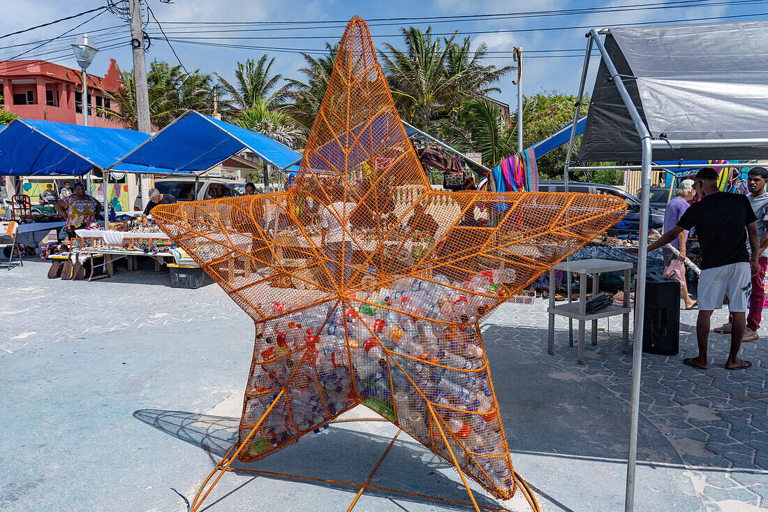 A metal bin in the shape of a starfish for recycling plastic water bottles in the open market in San Pedro,Ambergris Caye,Belize.