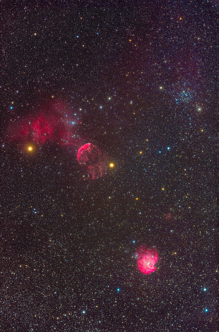 A framing of a field in southwestern Gemini rich in star clusters and nebulas. At top right is the rich star cluster Messier 35 and its small more distant companion cluster NGC 2158. At bottom right is the emission nebula NGC 2174 that is over the border in northern Orion. Above centre is the supernova remnant IC 443 arcing to the east of the orange star Propus or Eta Geminorum. The large diffuse nebula at left is IC 444 above the orange star Tejat Posterior or Mu Geminorum. The large,loose cluster Collinder 89 is embedded in IC 444. That region also has some blue reflection nebulosity,as does