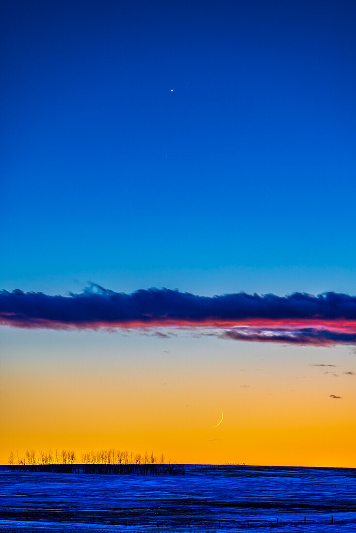 Venus in a close conjunction with dimmer Saturn in the evening twilight on January 22,2023. They were 22 arc minutes apart this evening. The 1-day-old waxing crescent Moon is below the planet pair deep in the twilight. The magnitude 2.8 star Deneb Algiedi,aka Delta Capricorni,is faintly visible below Venus. Venus was magnitude -3.9 while Saturn was magnitude 0.8.