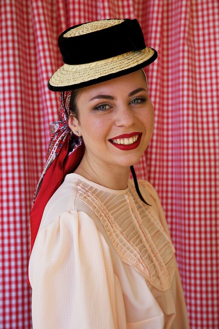 Spain, Canary Islands, Tenerife Island, young woman in traditional Canarian clothes during a romería, a village festival