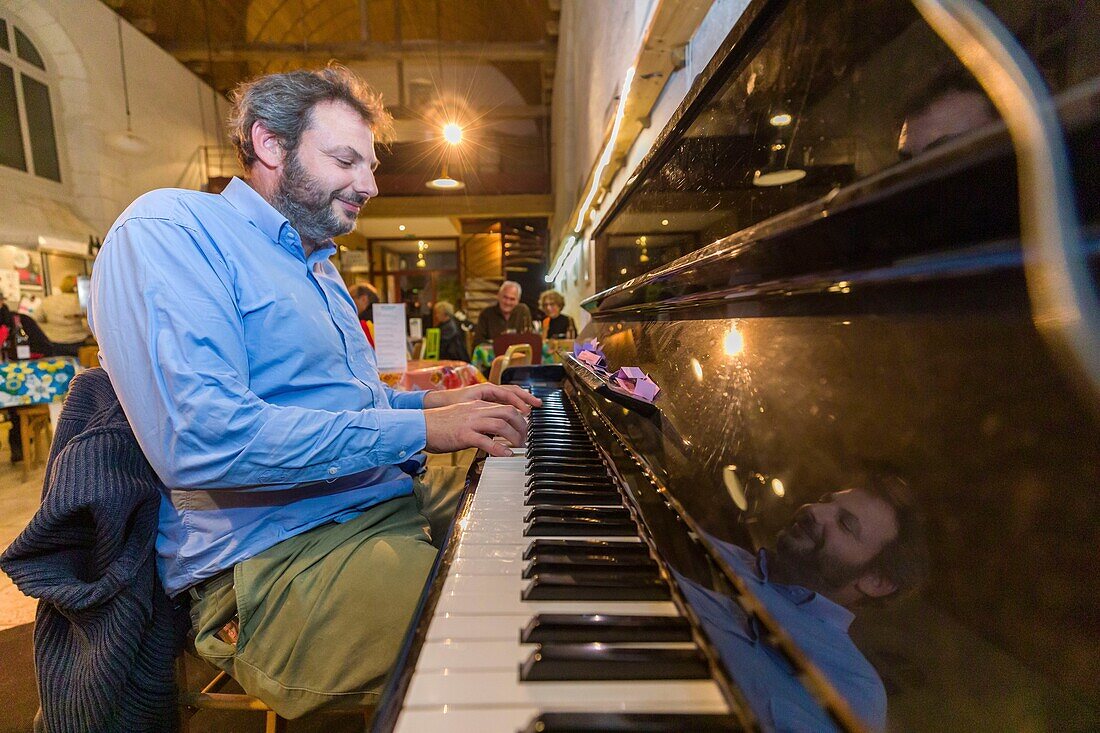 France, Indre et Loire, Champigny sur Veudes, old chapel transformed into a bar, the pianist