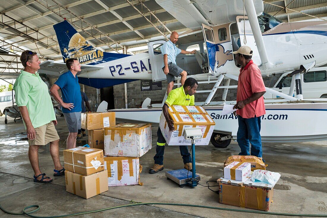 Papua New Guinea, East Sepik Province, Sepik River Region, Wewak City, Boram Airport, Samaritan Aviation Missionary Company Hangar, loading of polio vaccines delivered in the Sepik River area by seaplane during 2019 Polio Outbreak