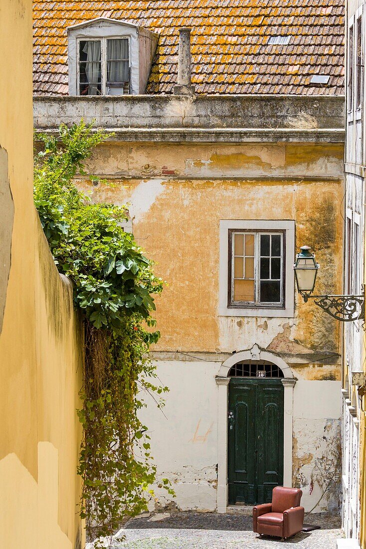 Portugal, Lisbon, Sant'ana district, armchair in an old street