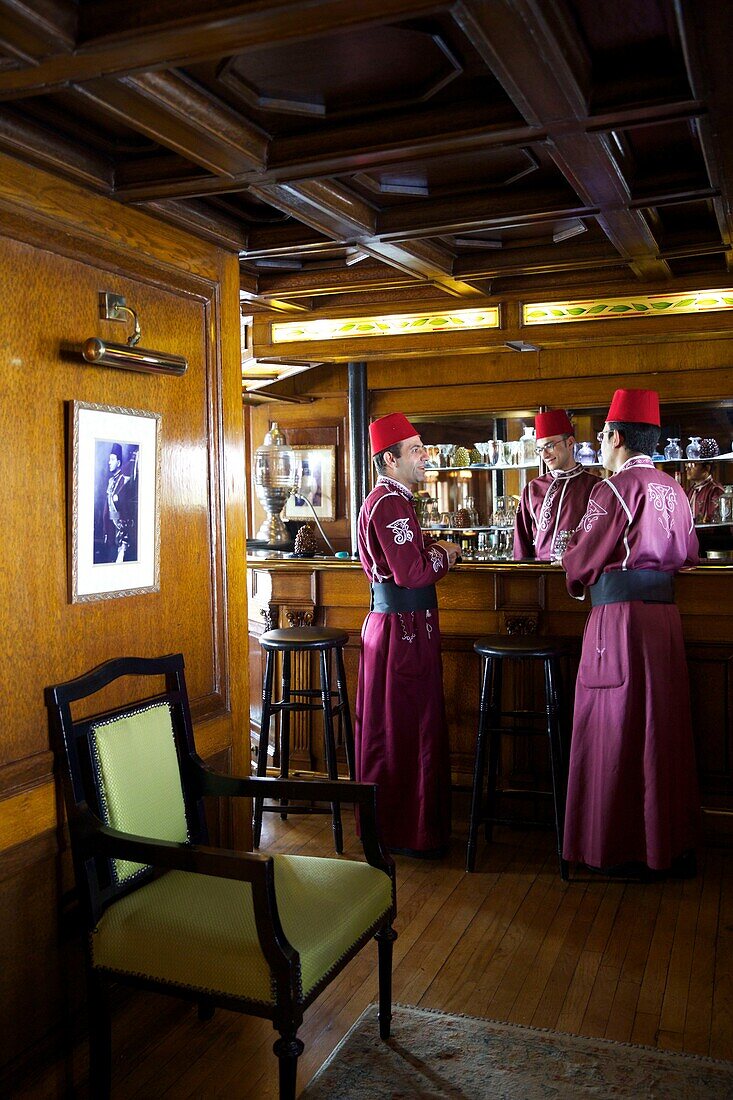 Egypt, Upper Egypt, Nile Valley, staff member of the Steam Ship Sudan, the last steamboat cruising the Nile, in period costume and wearing tarts in front of the British bar of the ship