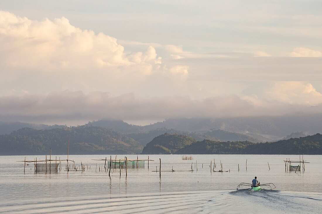 Philippines, Palawan, Malampaya Sound Protected Landscape and Seascape, fisherman sailling on his boat