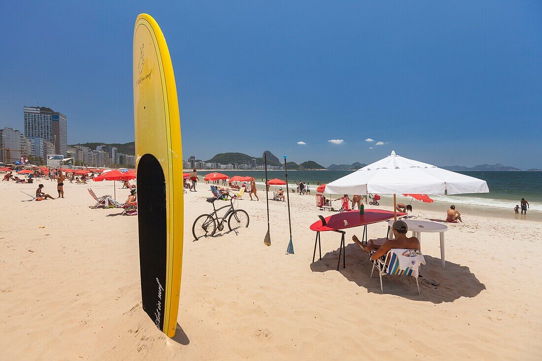 Brazil, state of Rio de Janeiro, city of Rio de Janeiro, Copacabana beach, Carioca landscapes between the mountain and the sea classified UNESCO World Heritage, surfboard stuck vertically in the sand