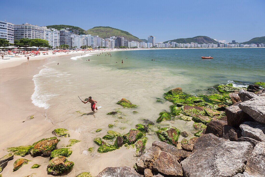 Brasilien,Bundesstaat Rio de Janeiro,Stadt Rio de Janeiro,Copacabana-Strand,Carioca-Landschaften zwischen Berg und Meer,die zum UNESCO-Welterbe gehören,Gesamtansicht und Kind,das aus dem Meer kommt