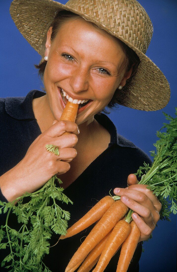 A Woman Eating Fresh Carrots